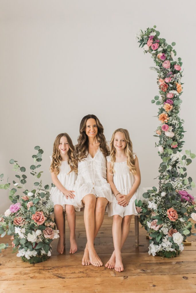 Mother and her girls photographed in Memorial, Houston, Texas motherhood mini portrait session with florals and neutral tones.