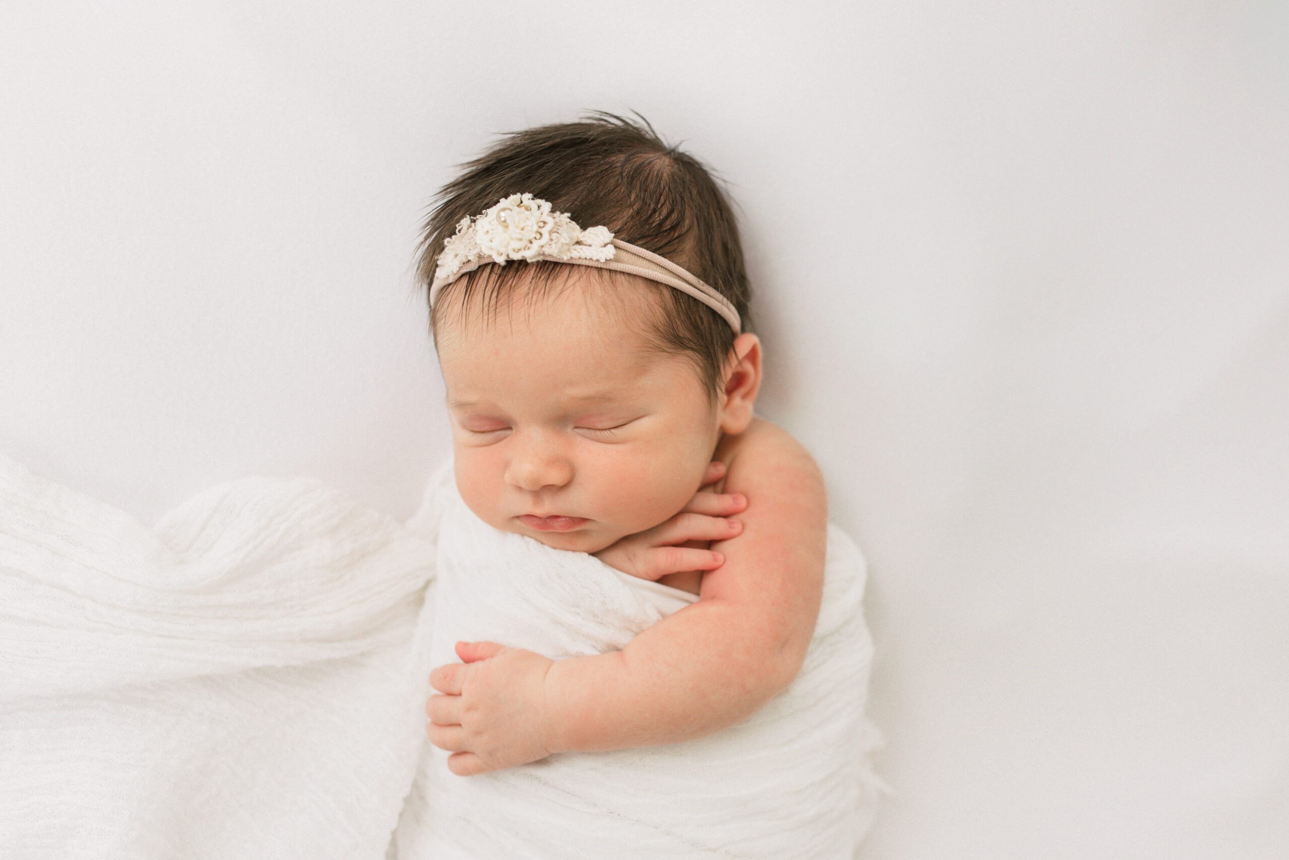 Newborn baby girl with parents and proud big brother during a luxury newborn photography session in Friendswood, Texas near Houston.